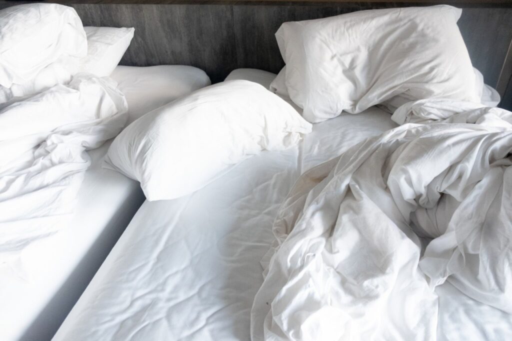 Side-by-side of messy, sweaty bed vs. perfectly made bed with crisp sheets - "Before & After My Sheet Revolution