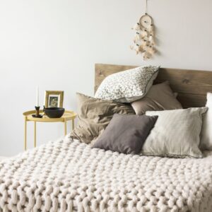The perfect Airbnb bed: Crisp white percale sheets, cloud-like duvet, and textured throw blanket create instant guest appeal