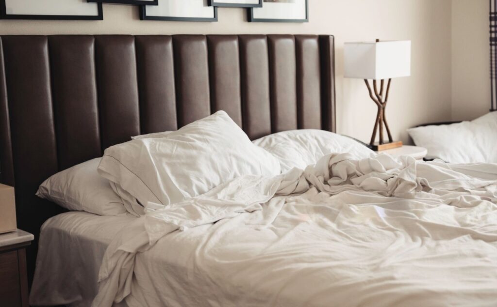 Hotel-style perfectly made percale bed vs. rumpled sateen sheets