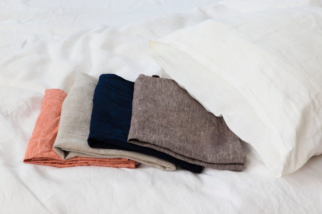 Image: A comparison of popular pillowcase materials: cotton, linen, and silk.