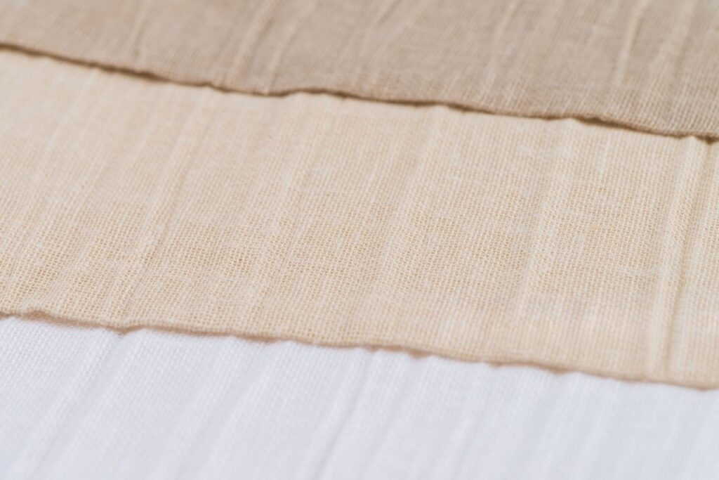 Alt Text: “Different bedding fabrics like cotton, linen, and bamboo that affect sleep comfort.”