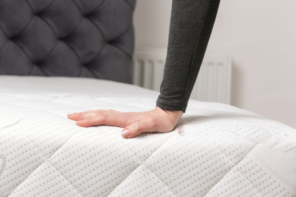 Alt Text: “Mattress and pillow support play a key role in spinal alignment and sleep quality.”