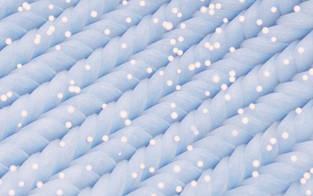 A microscopic view reveals the secret: cotton's scaly surface vs. microfiber's ultra-fine, smooth strands.