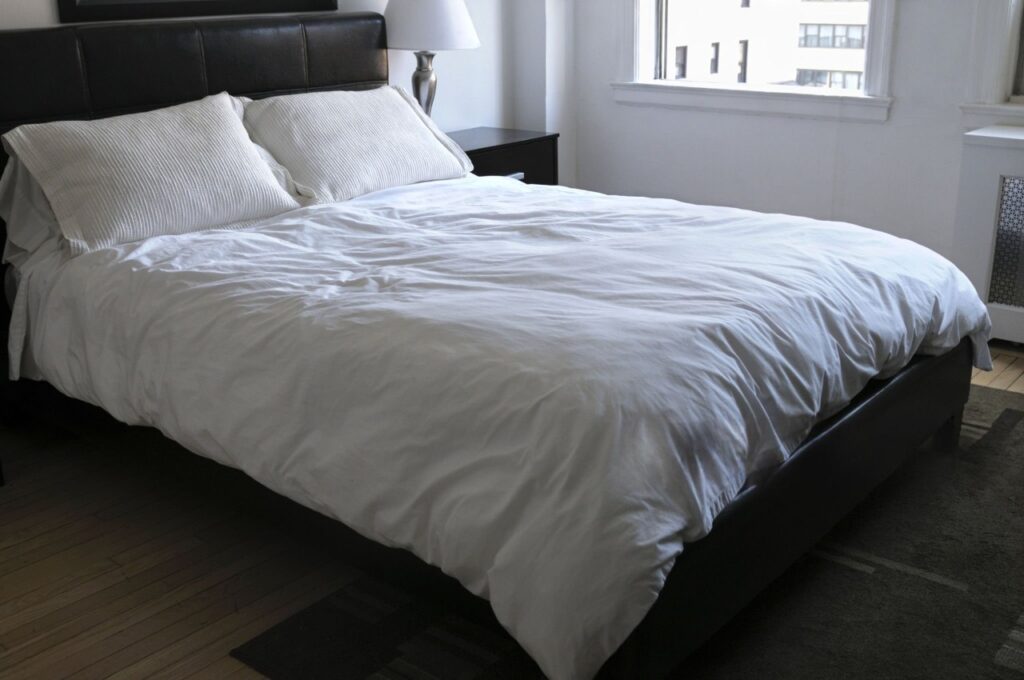 Image: The final result: a perfectly made bed with crisp, cool percale sheets, promising a night of restful, breathable sleep.