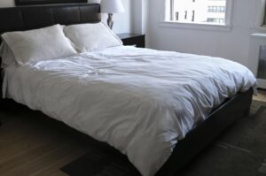 Image: The final result: a perfectly made bed with crisp, cool percale sheets, promising a night of restful, breathable sleep.